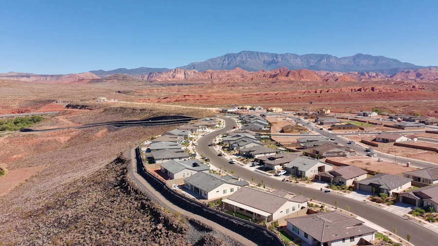 Aerial view of a desert neighborhood with red-rock mountains behind it
