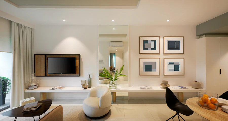 Bright, modern apartment living room with a lounge chair and framed art